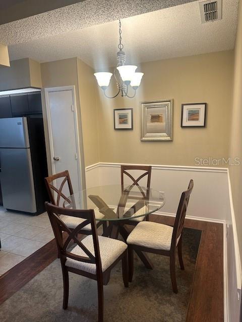 1793 Hampton Lane, Unit 110 Palm Harbor, FL 34683 - Photo 7 of 35 a view of a dining room with furniture and wooden floor