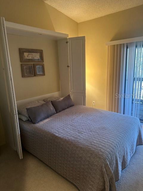 1793 Hampton Lane, Unit 110 Palm Harbor, FL 34683 - Photo 10 of 35 a bedroom with a bed and wooden floor