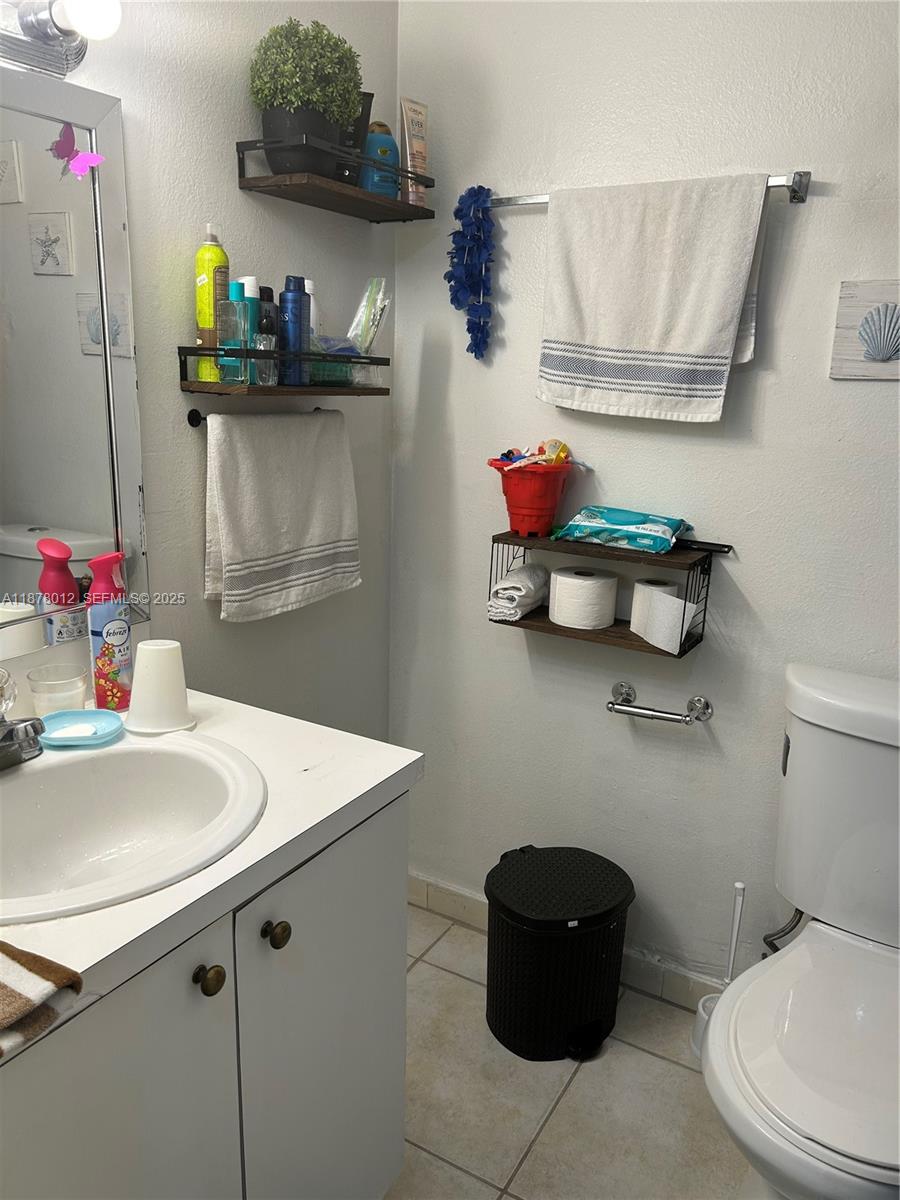 17901 Northwest 68th Avenue, Unit T101 Hialeah, FL 33015 - Photo 11 of 45 a bathroom with a sink and a mirror