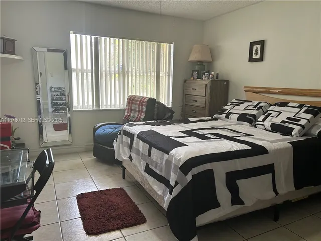 a bedroom with a bed and a night stand