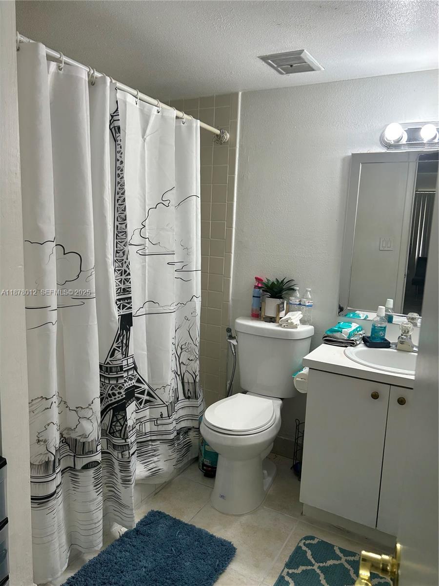 17901 Northwest 68th Avenue, Unit T101 Hialeah, FL 33015 - Photo 16 of 45 a bathroom with a sink toilet and shower