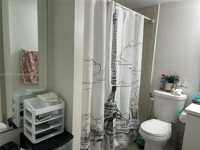 a kitchen with a sink a stove and cabinets