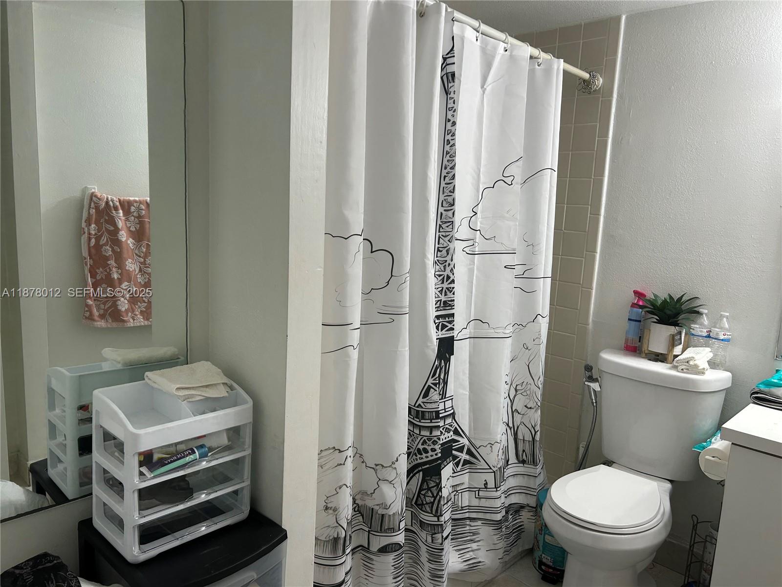 17901 Northwest 68th Avenue, Unit T101 Hialeah, FL 33015 - Photo 17 of 45 a bathroom with a toilet a sink and a shower