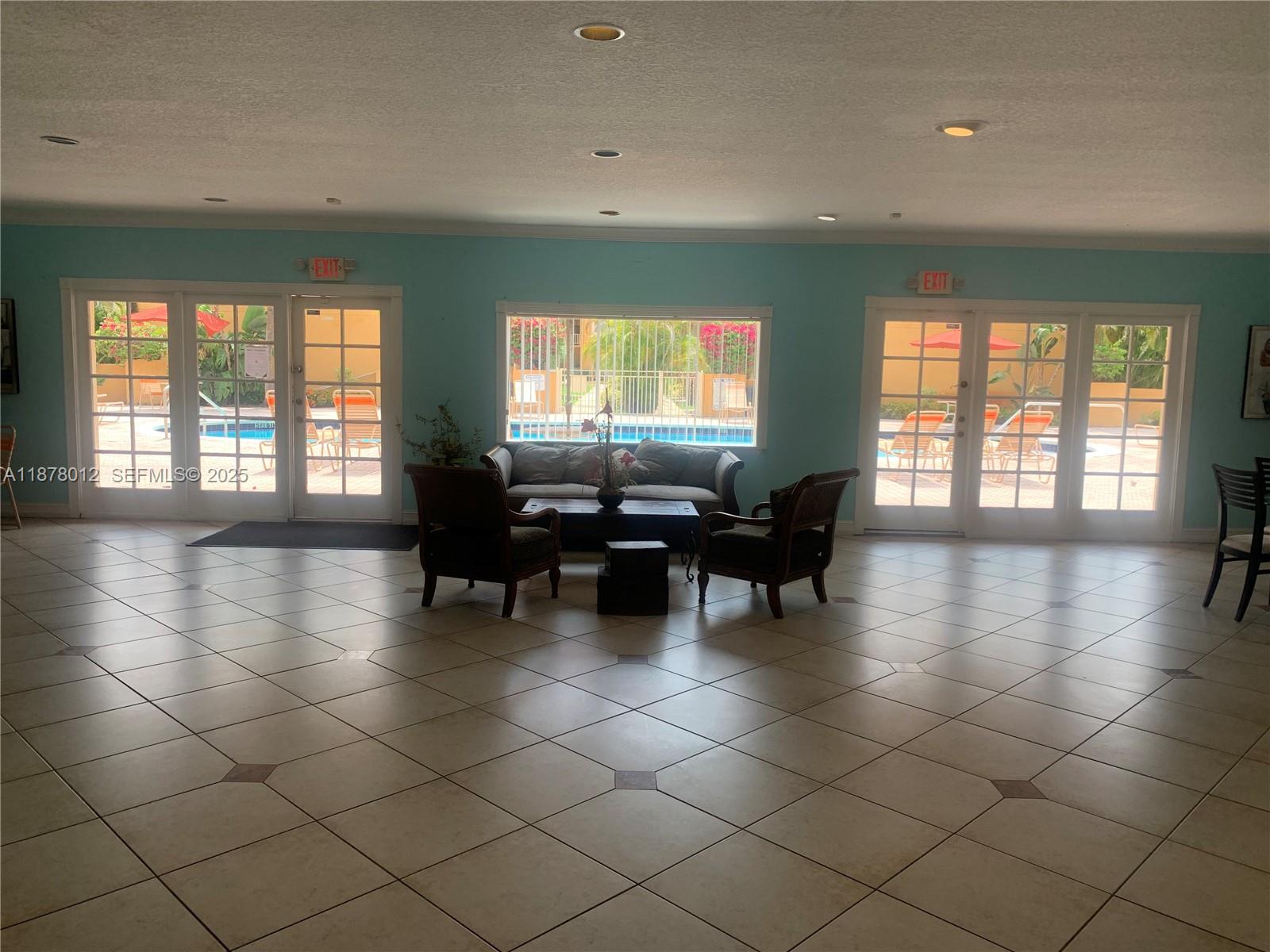 17901 Northwest 68th Avenue, Unit T101 Hialeah, FL 33015 - Photo 33 of 45 a lobby with furniture and large windows