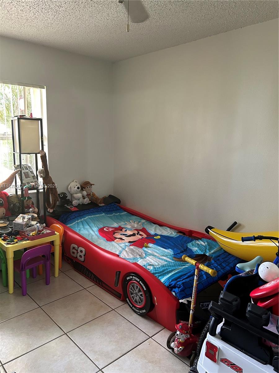 17901 Northwest 68th Avenue, Unit T101 Hialeah, FL 33015 - Photo 7 of 45 a room with furniture and gym equipment