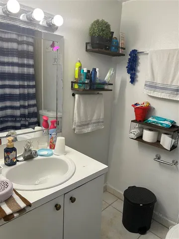 a kitchen with a sink a stove and cabinets