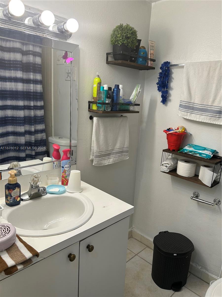 17901 Northwest 68th Avenue, Unit T101 Hialeah, FL 33015 - Photo 10 of 45 a kitchen with a sink a stove and cabinets