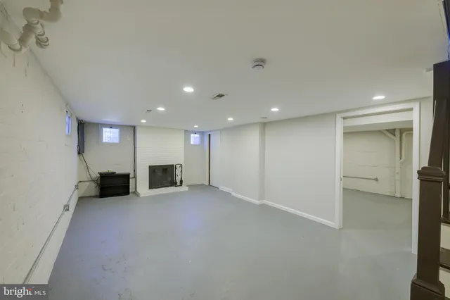 an empty room with a mirror and a projector