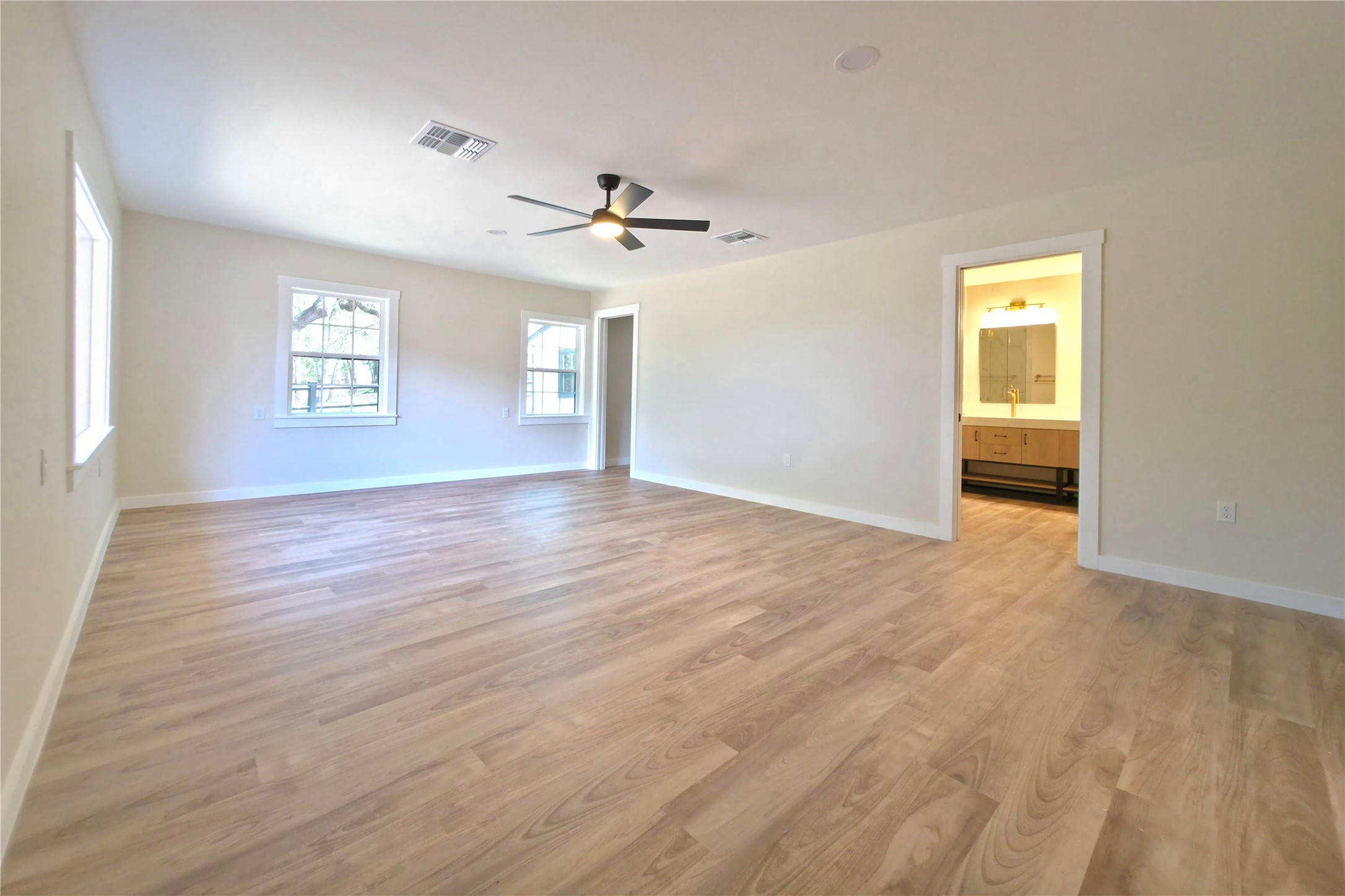 109 Cernosek Road La Grange, TX 78945 - Photo 25 of 32 an empty room with wooden floor ceiling fan and windows