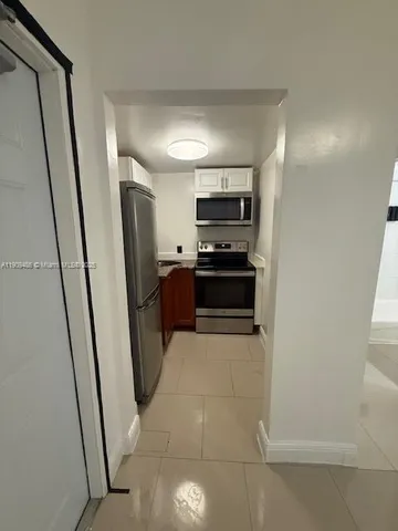 a kitchen with stainless steel appliances a refrigerator and a sink