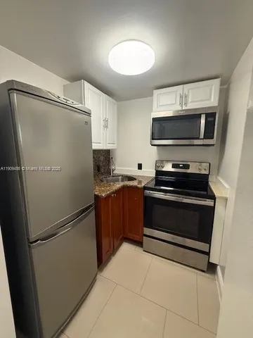 a kitchen with a refrigerator stove and microwave