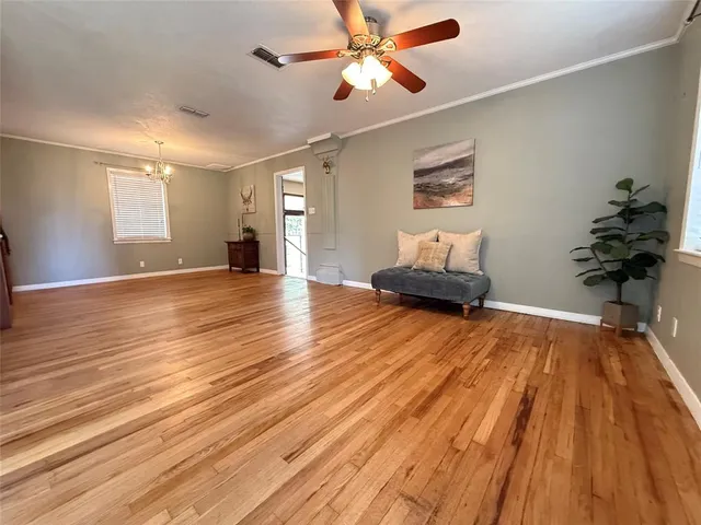a view of an empty room and wooden floor