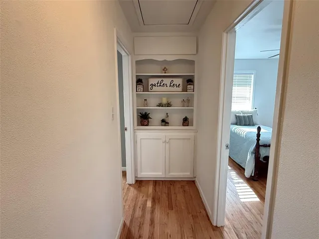 a view of closet with wooden floor