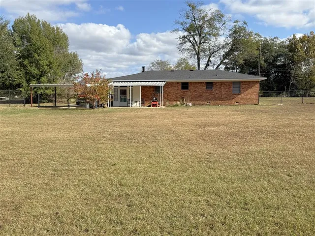 a front view of house with yard space and trees