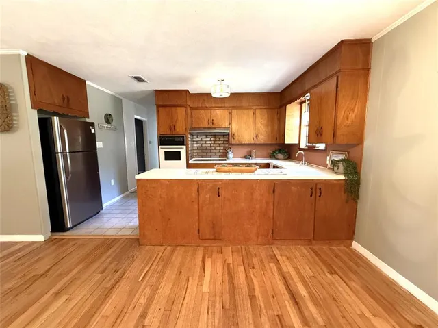a room with wooden floors and wooden cabinets