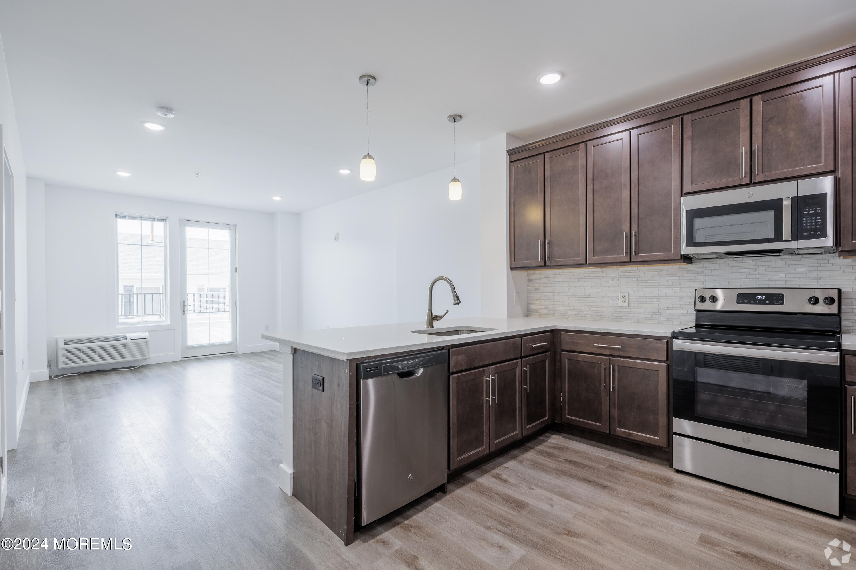 126 Main Street, Unit 410 Matawan, NJ 07747 - Photo 3 of 13 a kitchen with stainless steel appliances granite countertop wooden cabinets a sink and a stove