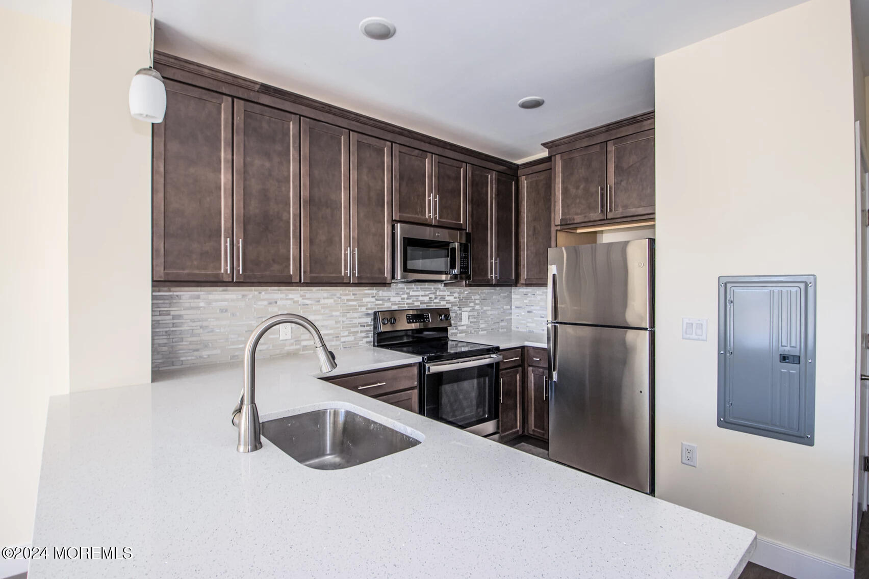 126 Main Street, Unit 410 Matawan, NJ 07747 - Photo 4 of 13 a kitchen with stainless steel appliances granite countertop a refrigerator and a sink