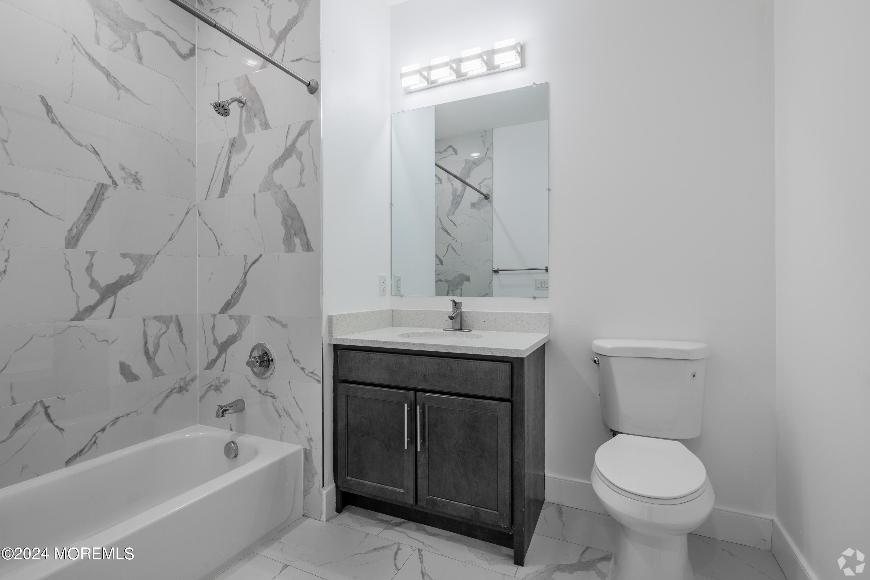 126 Main Street, Unit 410 Matawan, NJ 07747 - Photo 9 of 13 a bathroom with a sink toilet and bathtub