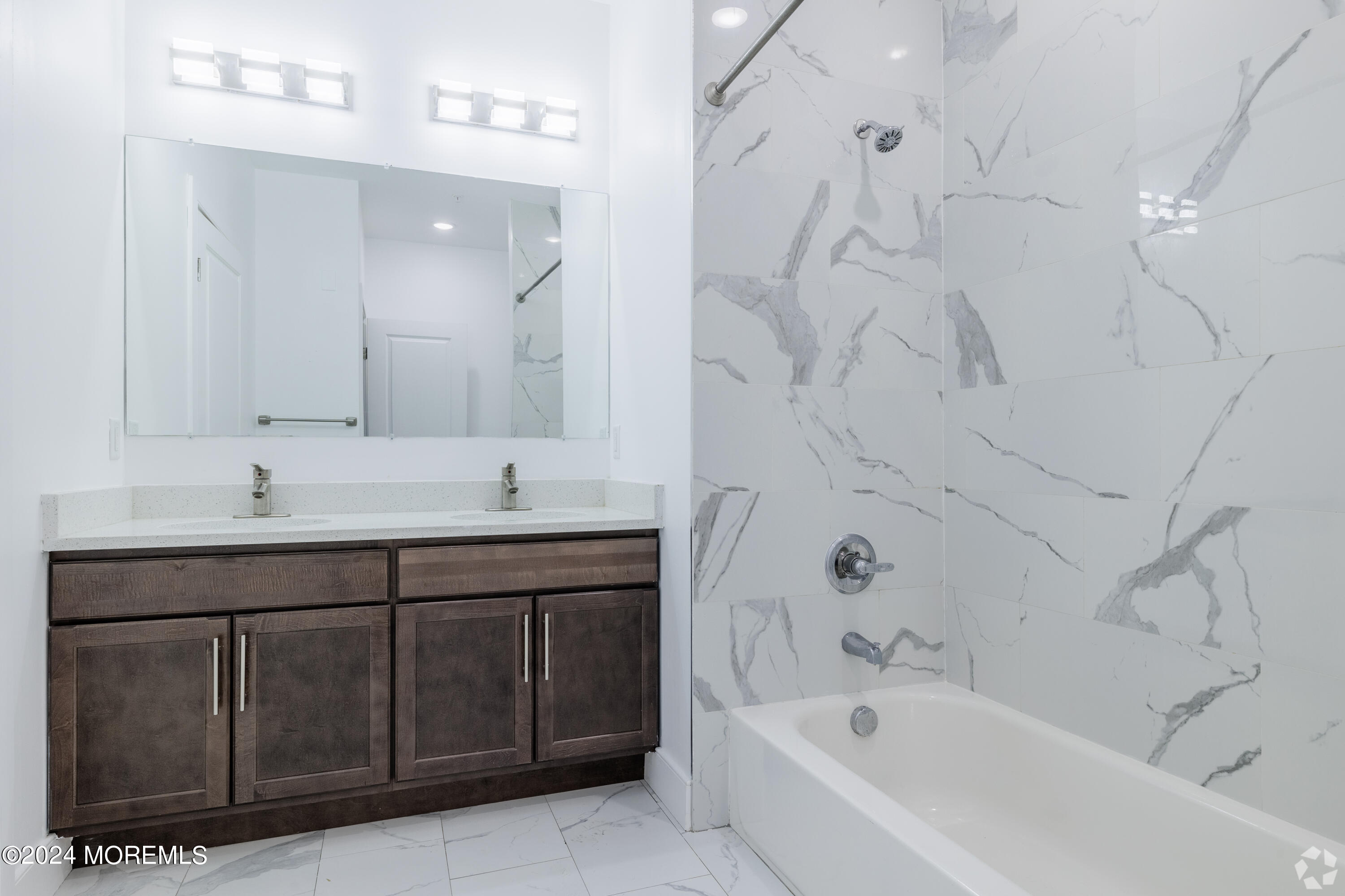 126 Main Street, Unit 410 Matawan, NJ 07747 - Photo 10 of 13 a bathroom with a tub sink and mirror