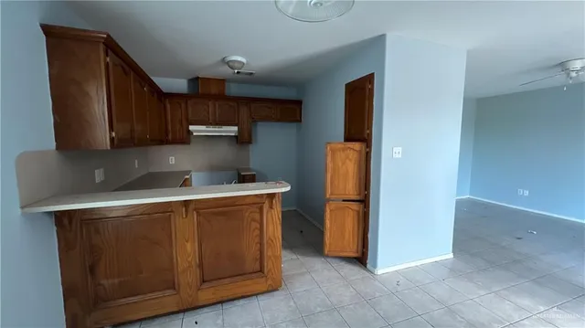 a kitchen with a refrigerator sink and cabinets