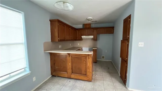 a utility room with cabinets washer and dryer