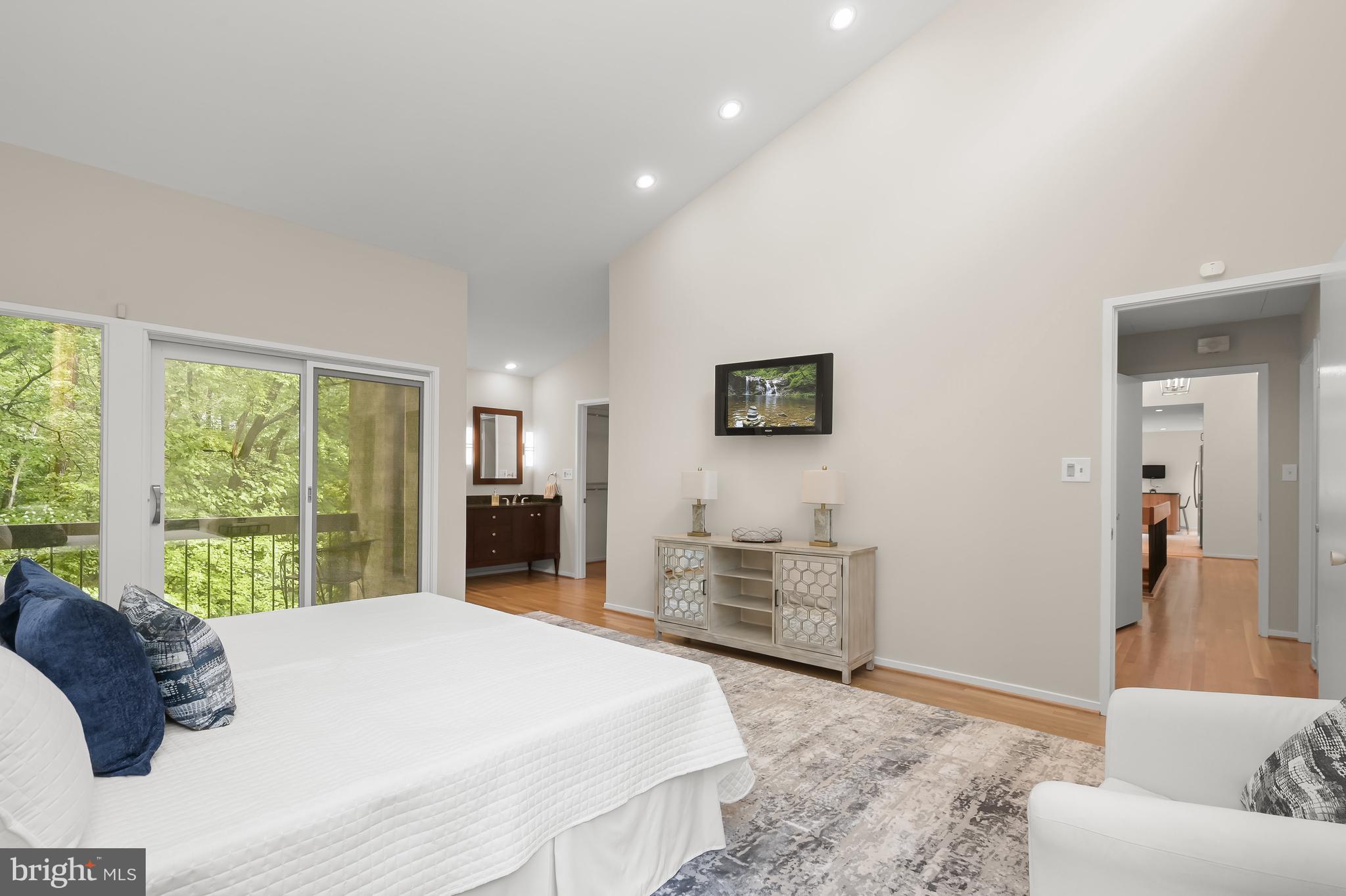 8805 Quiet Stream Court Potomac, MD 20854 - Photo 19 of 42 a bed room with a bed and a television