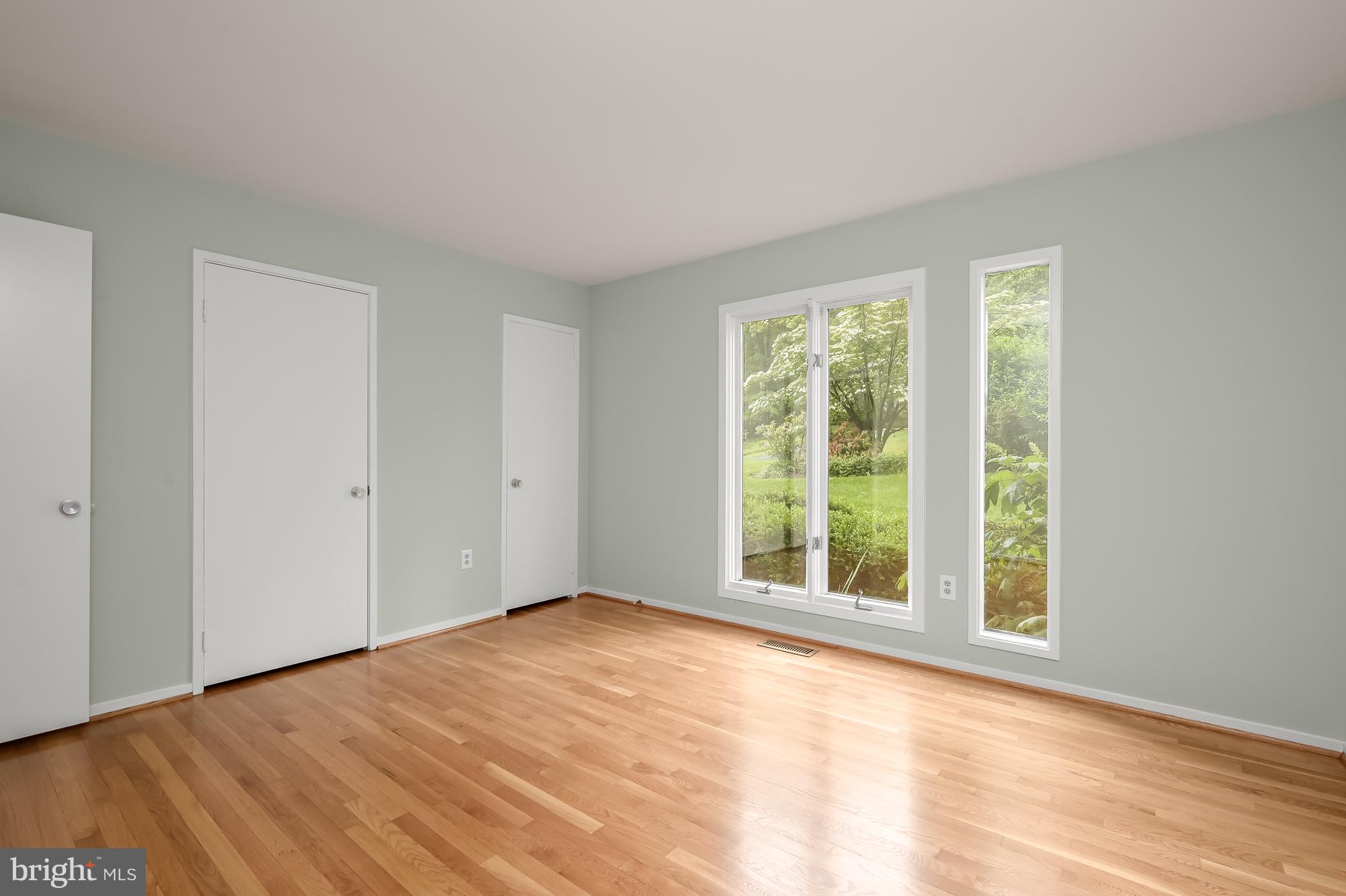 8805 Quiet Stream Court Potomac, MD 20854 - Photo 23 of 42 a view of an empty room with wooden floor and a window
