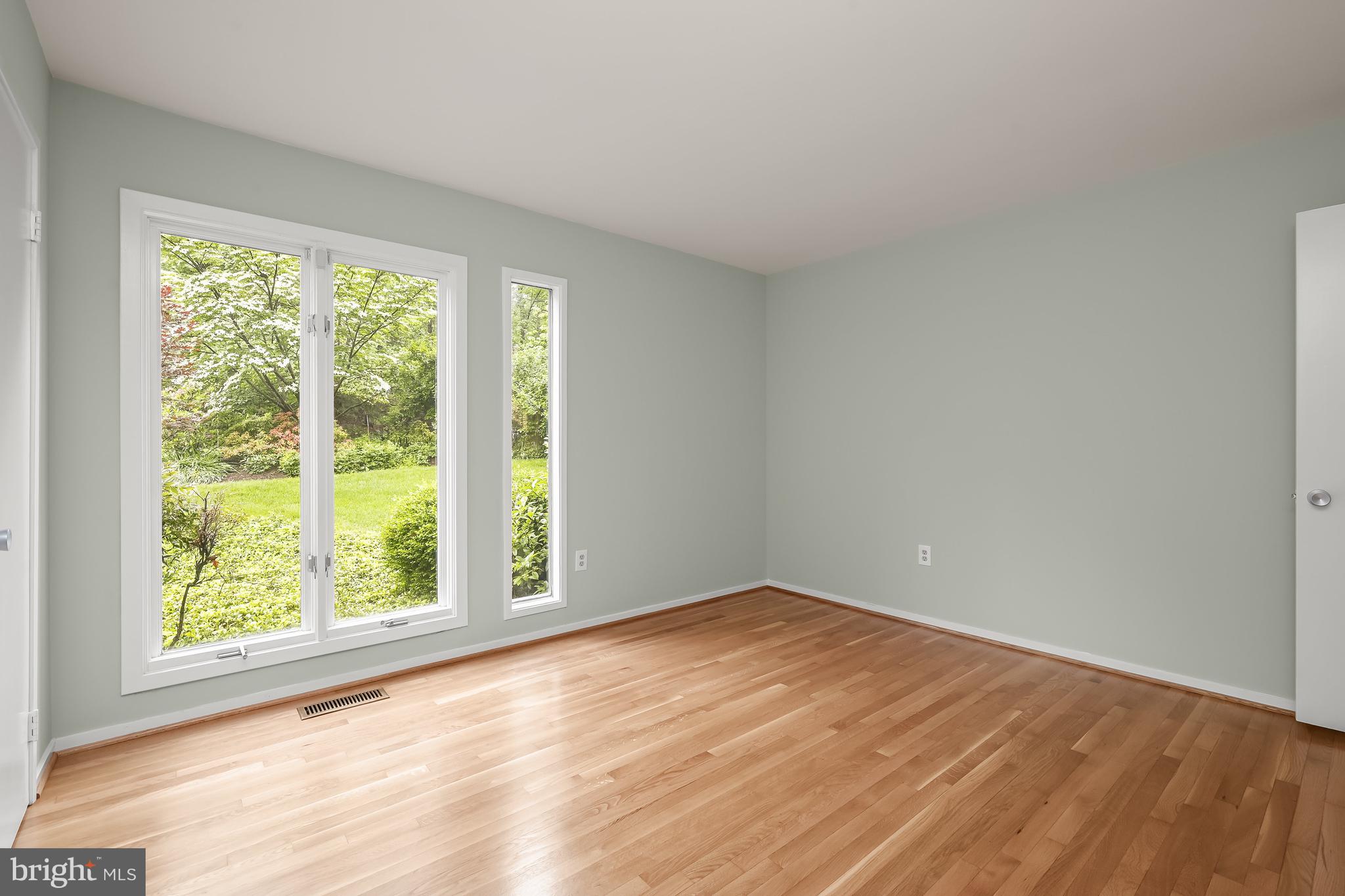 8805 Quiet Stream Court Potomac, MD 20854 - Photo 25 of 42 a view of an empty room with wooden floor and a window