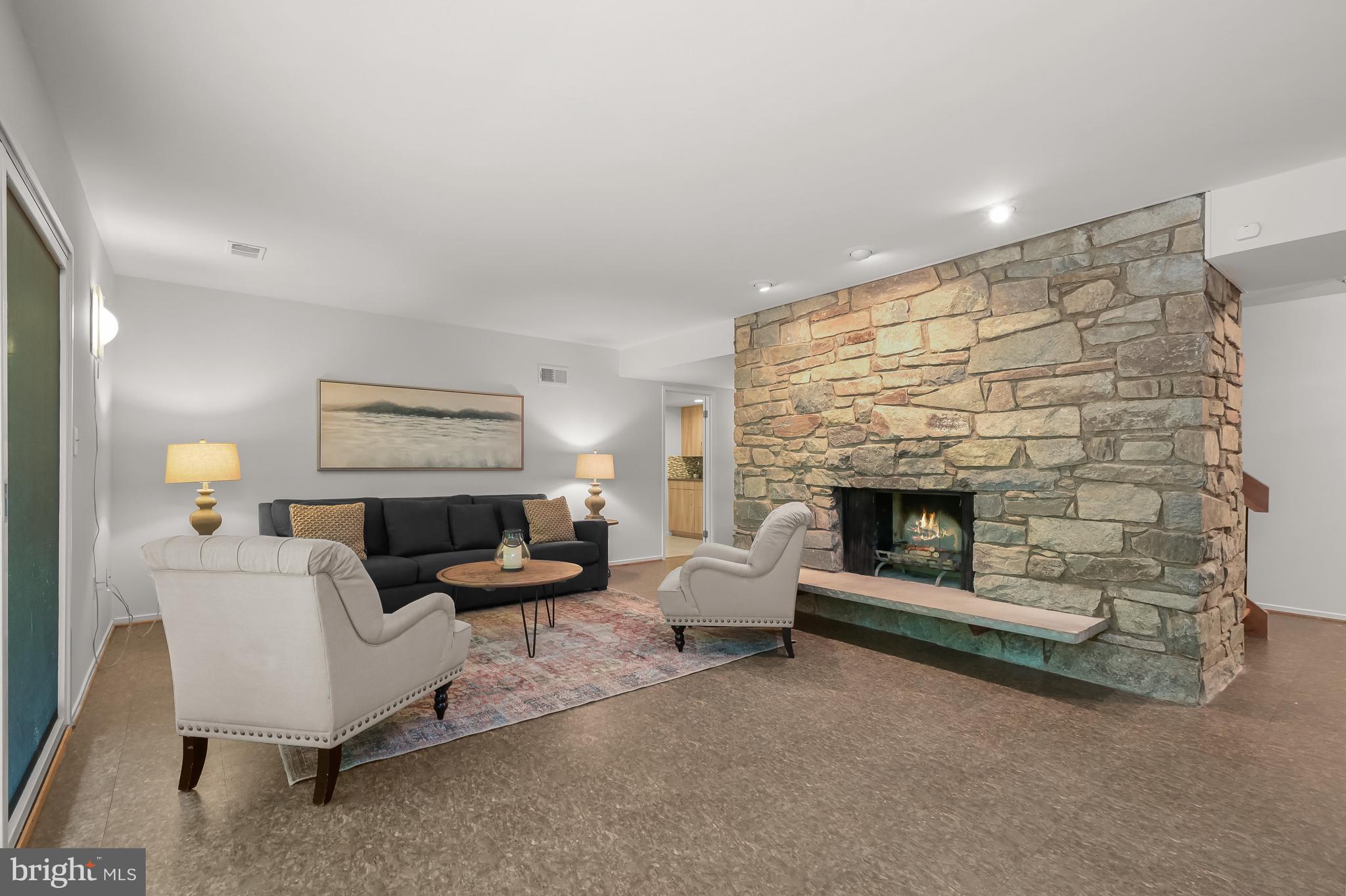 8805 Quiet Stream Court Potomac, MD 20854 - Photo 29 of 42 a living room with furniture and a fireplace