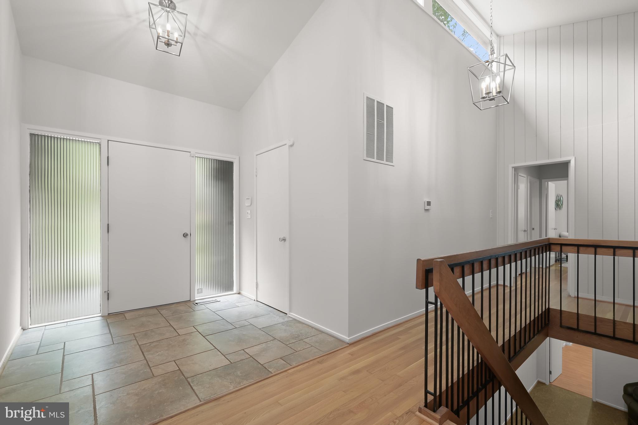 8805 Quiet Stream Court Potomac, MD 20854 - Photo 4 of 42 a view of a hallway with entryway and wooden floor