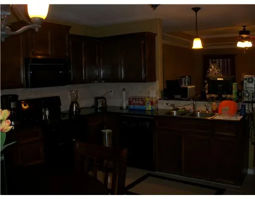 a kitchen with black cabinets and appliances