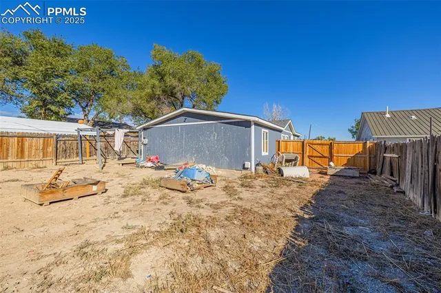 a backyard of a house with basket ball court