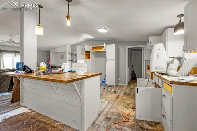 a living room with stainless steel appliances kitchen island granite countertop furniture