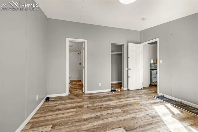 a view of a livingroom with wooden floor and white doors