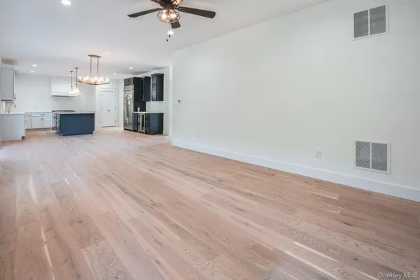 a view of a kitchen with a microwave and a ceiling fan