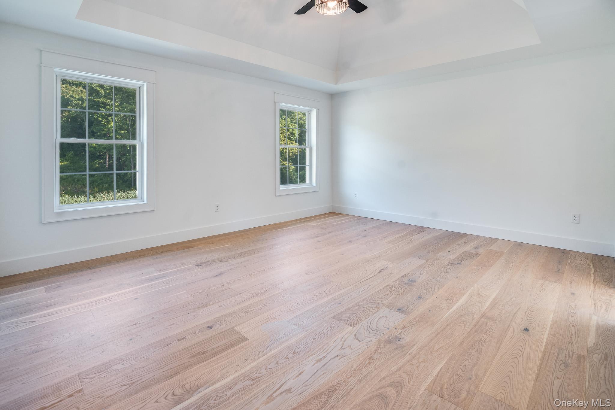 Lot 2 Hillside Lake Road Wappingers Falls, NY 12590 - Photo 14 of 28 an empty room with wooden floor and windows