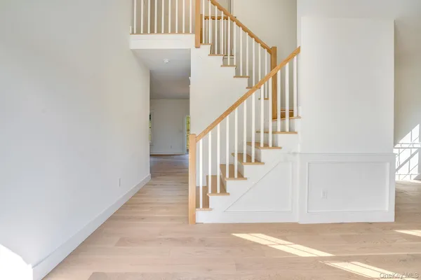 a view of staircase with white walls and a window