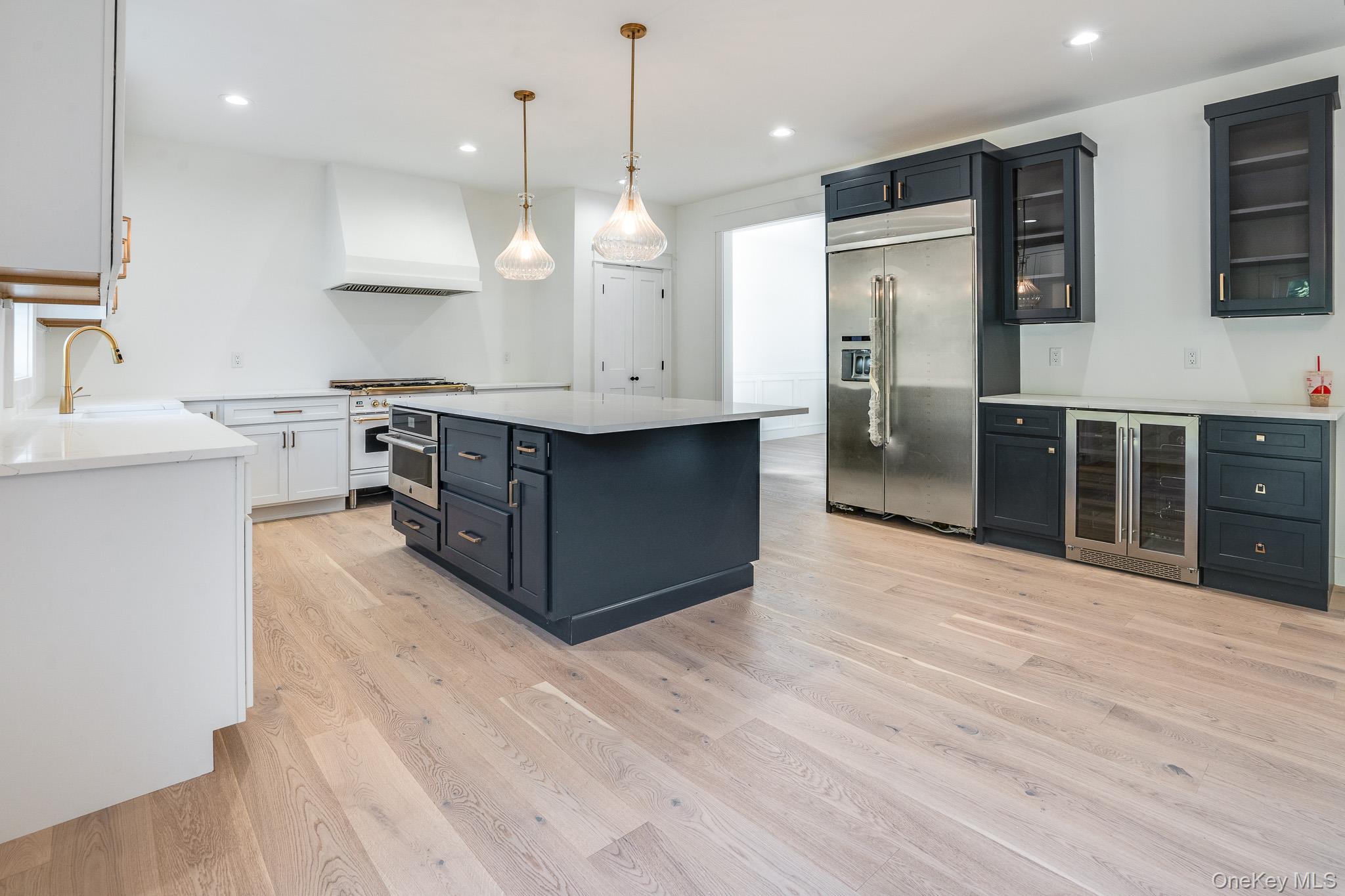 Lot 2 Hillside Lake Road Wappingers Falls, NY 12590 - Photo 8 of 28 a large kitchen with stainless steel appliances a large counter top a sink refrigerator and cabinets