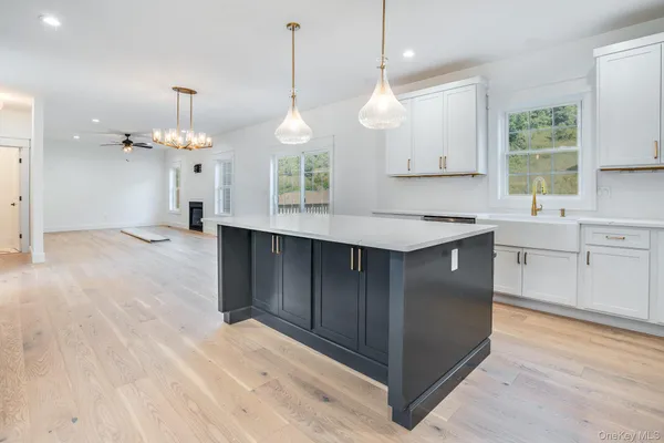 a kitchen with a refrigerator a sink and cabinets