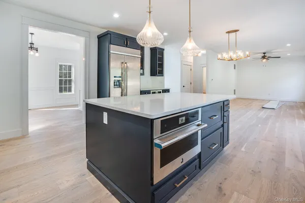 a kitchen with a stove and a wooden floor