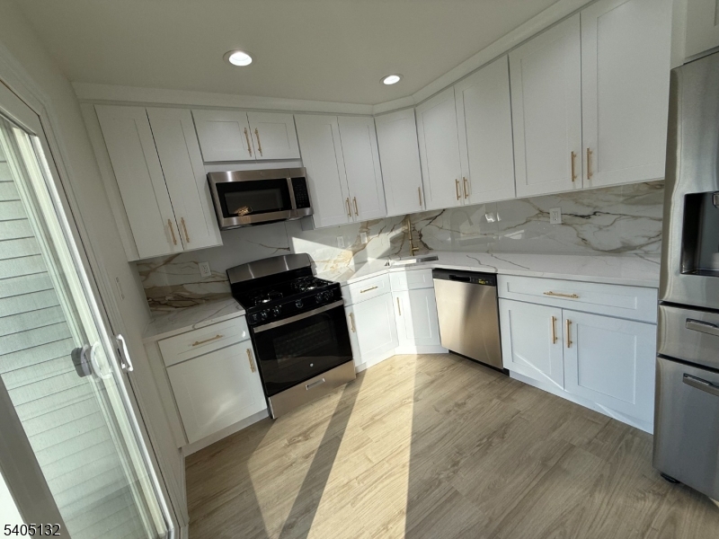 4202 Winder Drive Bridgewater, NJ 08807 - Photo 13 of 26 a kitchen with granite countertop a sink and steel appliances