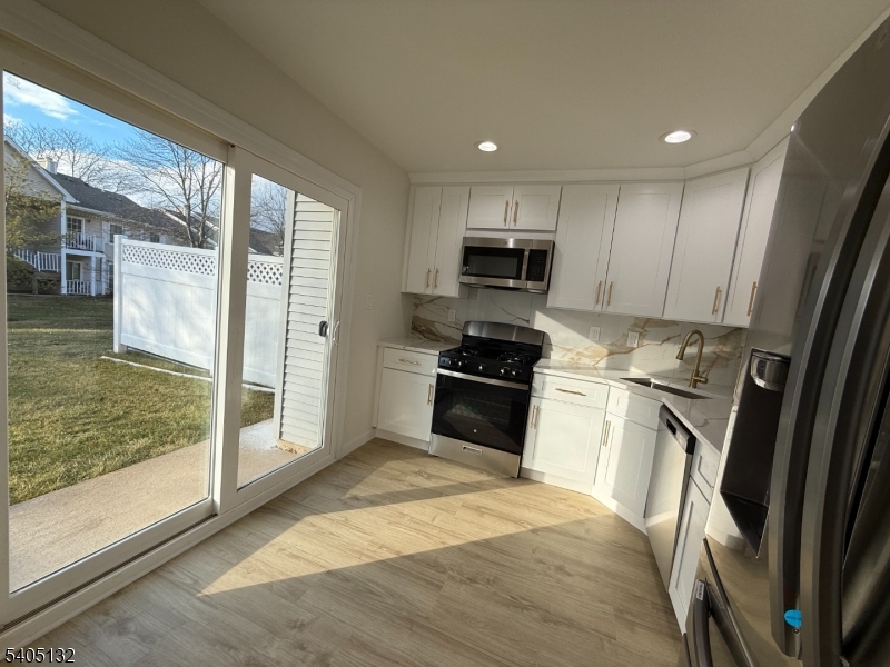 4202 Winder Drive Bridgewater, NJ 08807 - Photo 14 of 26 a kitchen with a refrigerator and a sink