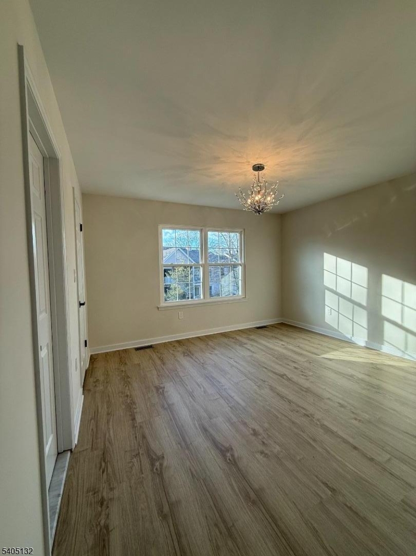4202 Winder Drive Bridgewater, NJ 08807 - Photo 20 of 26 an empty room with wooden floor cabinet and windows