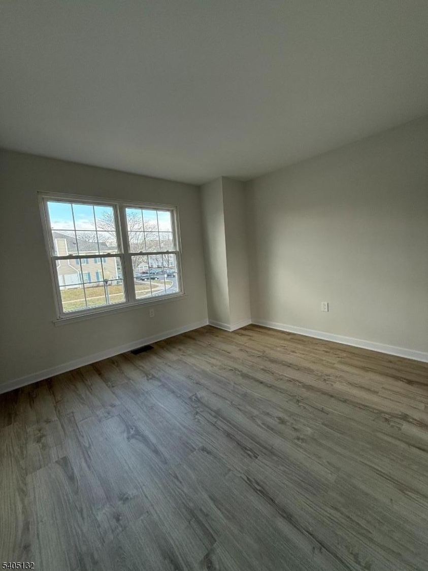 4202 Winder Drive Bridgewater, NJ 08807 - Photo 24 of 26 an empty room with wooden floor and windows