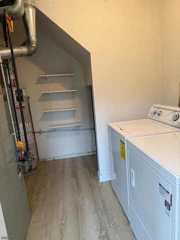 a view of storage and utility room with washer and dryer