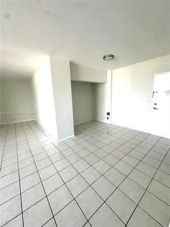 a view of an empty room and wooden floor