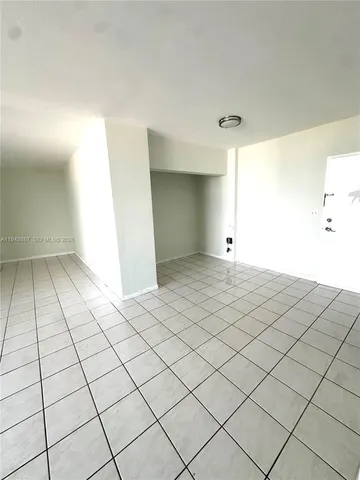 a view of an empty room and wooden floor