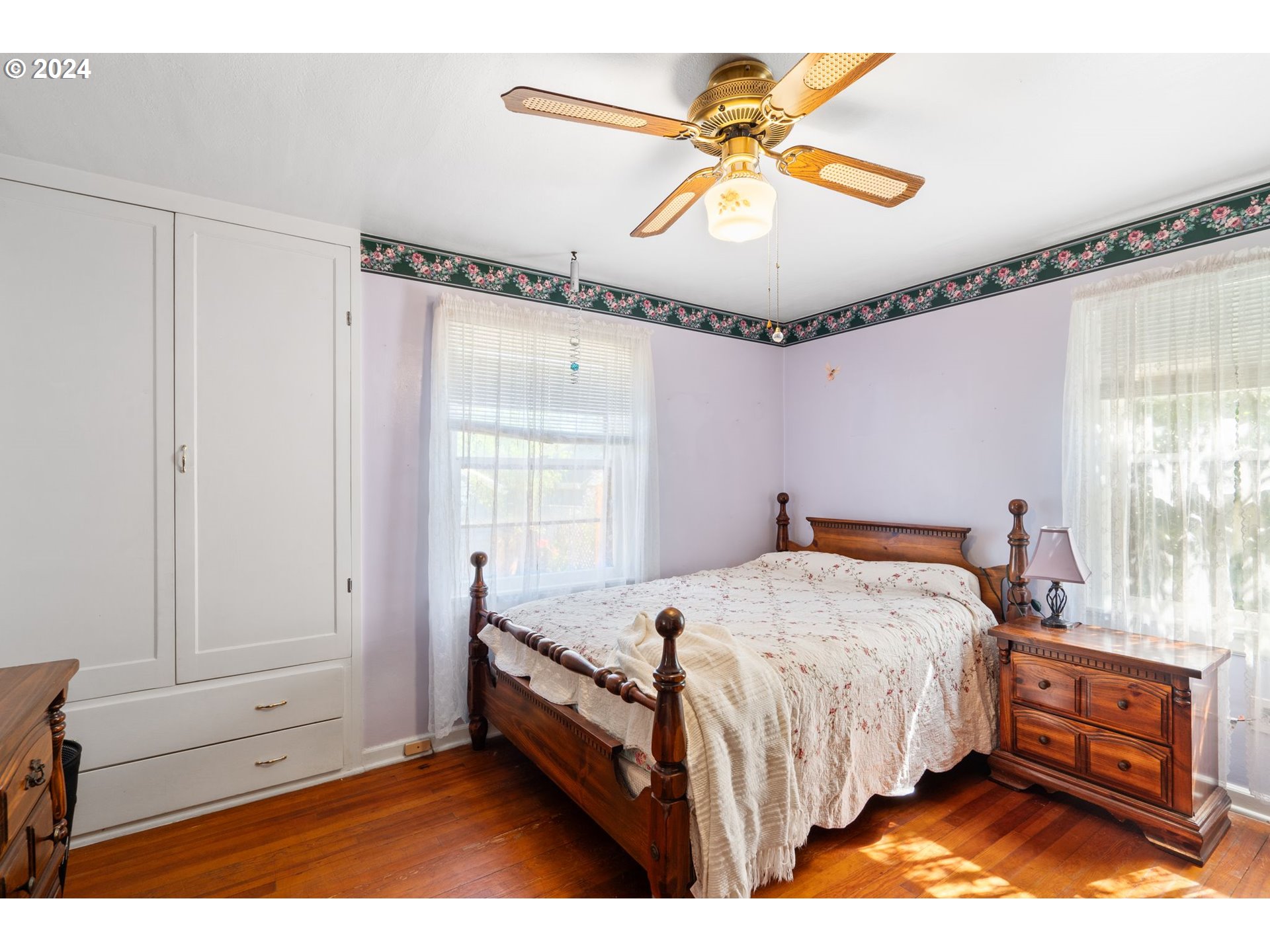 5811 Southeast Knight Street Portland, OR 97206 - Photo 4 of 9 a bed room with a bed and a chandelier