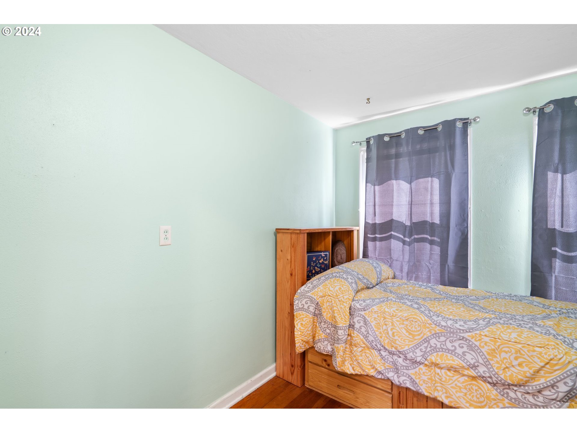 5811 Southeast Knight Street Portland, OR 97206 - Photo 7 of 9 a bedroom with a bed and a table