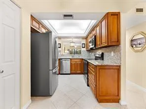 a kitchen with stainless steel appliances granite countertop a stove a sink and a refrigerator
